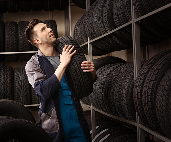 Male seller in car tire store